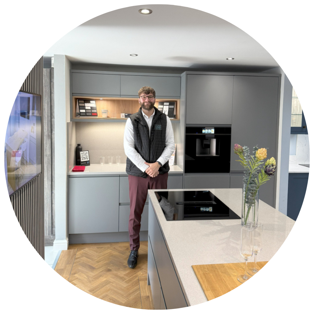 Ben Hopkinson Ben Hopkinson, team member at The Little Kitchen Factory, standing in a modern grey kitchen showroom