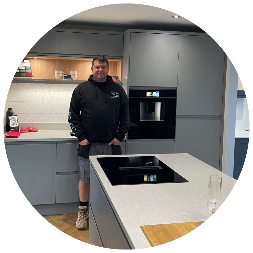 Darren Freebury | The Little Kitchen Factory Team Darren Freebury from The Little Kitchen Factory standing in a grey kitchen showroom