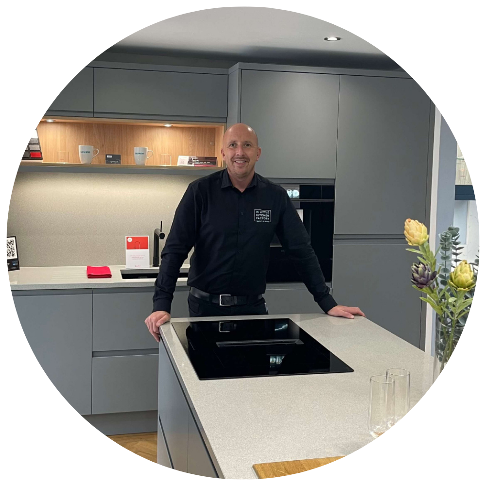Paul Jamison Paul Jamison, team member at The Little Kitchen Factory, standing in a modern grey kitchen showroom