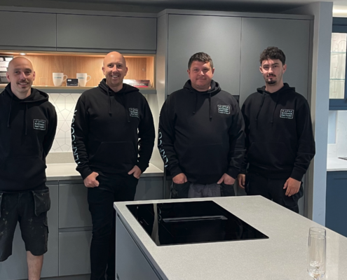 TLKF installation team - four team members in front of a completed kitchen installation